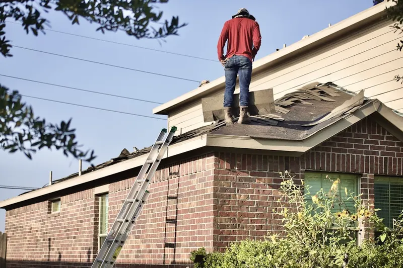 Professional roofer working on a residential roof in North Arlington